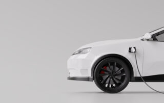 White electric vehicle plugged into a charging cable, highlighting EV battery charging and overall battery health concept.