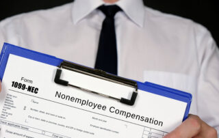A dealership finance professional holding a blue clipboard with a Form 1099-NEC Nonemployee Compensation tax document, representing auto loan options for self-employed buyers.